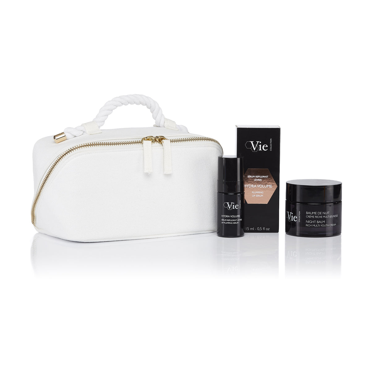 Vie Collection Night Balm Ritual Gift Set with Night Balm cream, Hydra Volume Lip Plumping Serum and its box, and a white pouch.