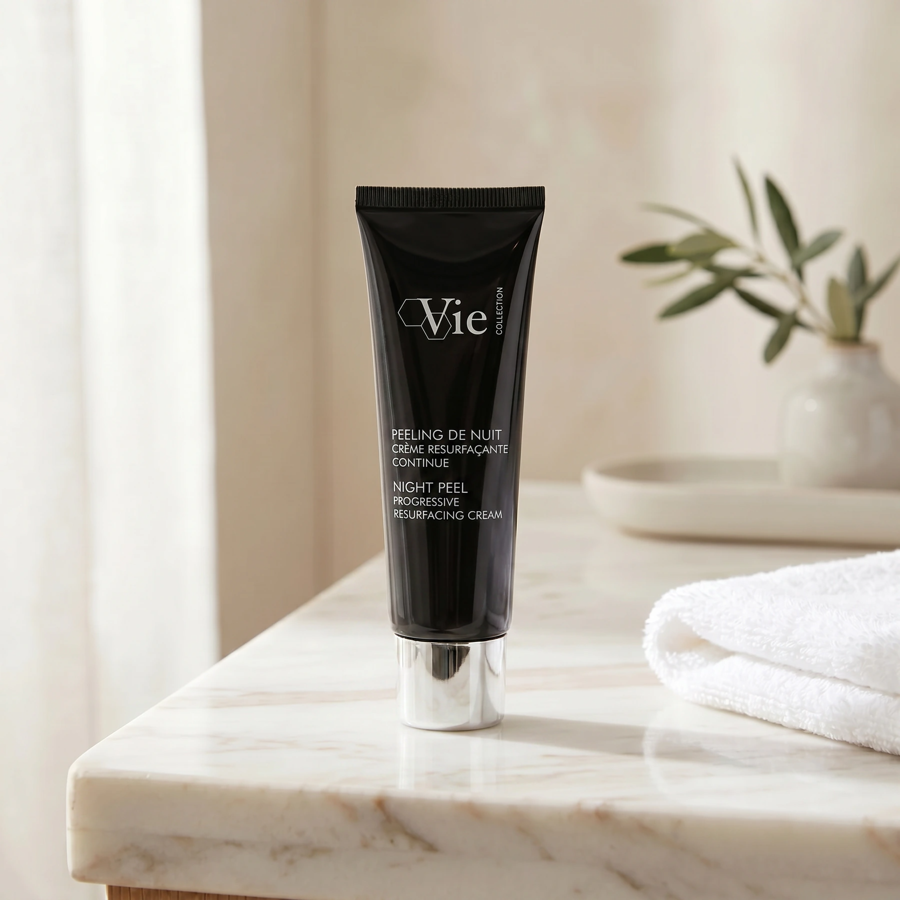 Vie Collection Night Balm Rich Multi-Youth Cream 50g on a marble bathroom counter with dried botanical in glass vase, warm candlelight, white waffle towel on marble tray, premium at-home evening skincare setting